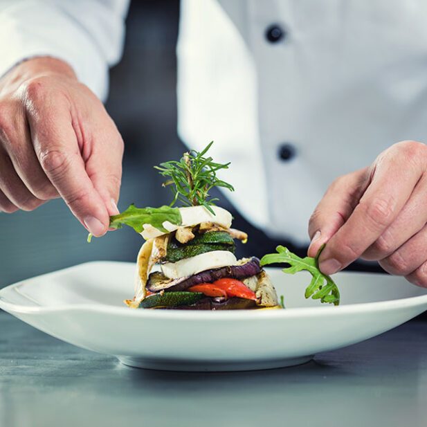 chef-in-restaurant-garnishing-vegetable-dish